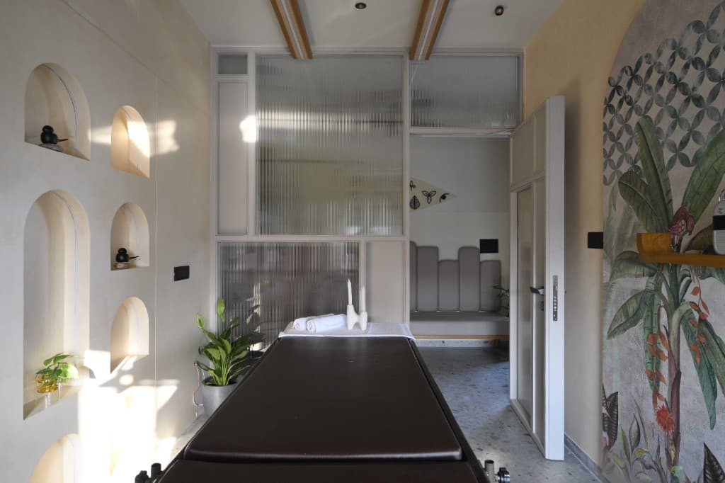 Ayurvedic treatment room with tropical mural at Shashvat Ayurveda